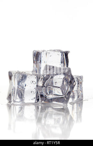 Wet square ice cubes on reflective white background. Copy space Stock Photo