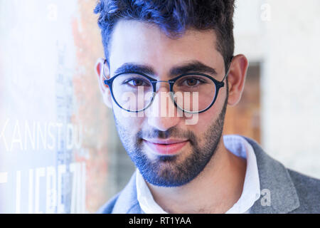 Portrait of bearded young businessman wearing glasses Stock Photo