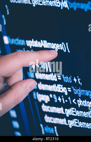 pointing on a stock chart at the computer screen with finger, closeup Stock Photo