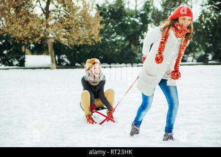 Two friends having fun in the snow Stock Photo