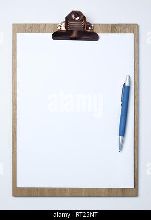Wooden clipboard with white sheet on