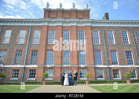 Queen Victoria, 2 gentlemen and her Baroness Lehzen stand in front of Kensington Palace and look at the grounds. Stock Photo