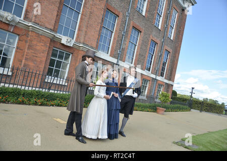 Queen Victoria, 2 gentlemen and her Baroness Lehzen stand in front of Kensington Palace and look at the grounds. Stock Photo