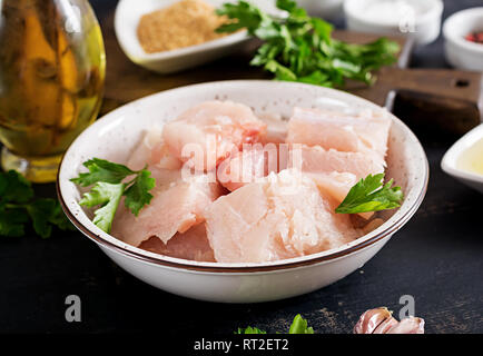 Ingredients for homemade Fish Cake cod, spinach, egg and breadcrumbs. Raw cutlets from minced cod. Stock Photo