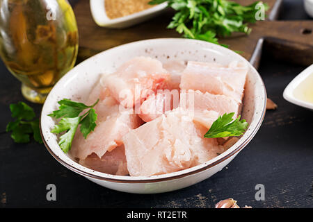 Ingredients for homemade Fish Cake cod, spinach, egg and breadcrumbs. Raw cutlets from minced cod. Stock Photo