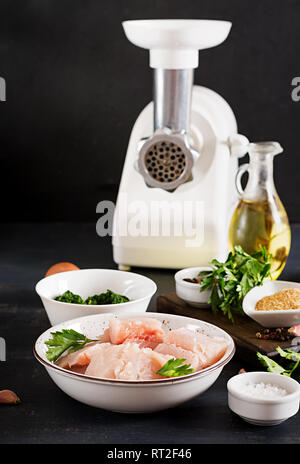 Ingredients for homemade Fish Cake cod, spinach, egg and breadcrumbs. Raw cutlets from minced cod. Stock Photo
