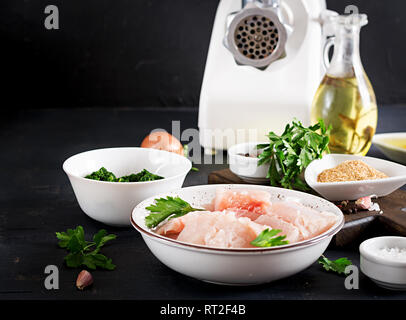 Ingredients for homemade Fish Cake cod, spinach, egg and breadcrumbs. Raw cutlets from minced cod. Stock Photo