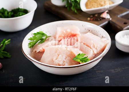 Ingredients for homemade Fish Cake cod, spinach, egg and breadcrumbs. Raw cutlets from minced cod. Stock Photo