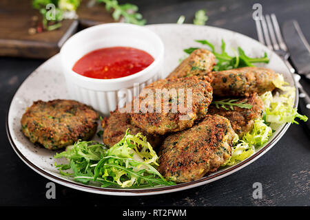 Home made Fish Cake cod, spinach and breadcrumbs. Served on plate with sauce. Cutlets from minced cod. Delicious and nutritious lunch or dinner. Stock Photo