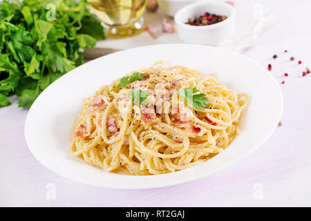 Classic homemade carbonara pasta with pancetta, egg, hard parmesan cheese and cream sauce. Italian cuisine. Spaghetti alla carbonara. Stock Photo