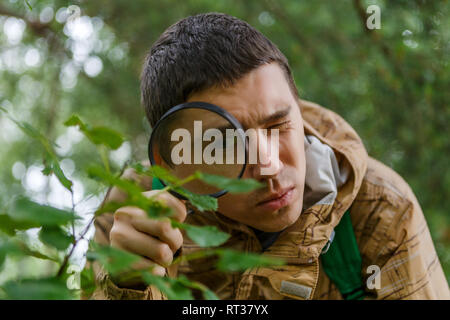 Image of young botanist with magnifying glass Stock Photo