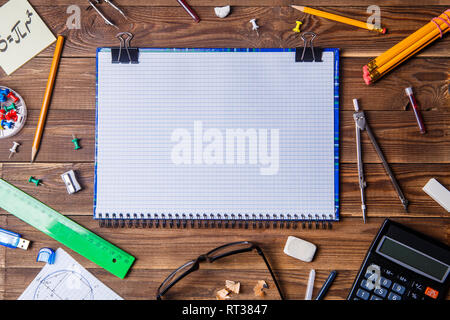 Student material with copybook for text on wooden table. Stock Photo