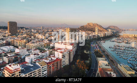 Aerial photography drone view Alicante cityscape above panorama main landmark in city center Santa Barbara castle on the Mount Benacantil moored yacht Stock Photo