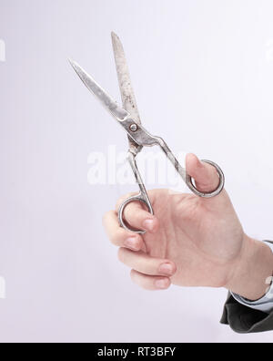 Man holding scissors on white isolated background Stock Photo