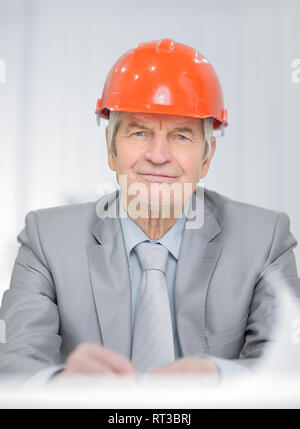 portrait of a senior engineer sitting at his Desk Stock Photo