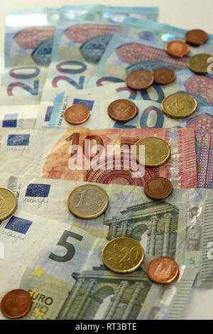 A Pile of Euro Notes and Coins Stock Photo