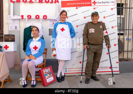 Moguer, Huelva, Spain - February 24, 2019: People dressed in old fashioned as red cross volunteer, in the Moguer 1900 Vintage Fair, to commemorate the Stock Photo