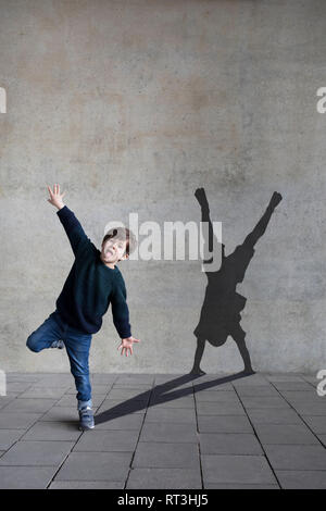 Germany, Duesseldorf, portrait of  little boy and shadow of Duesseldorf's cartwheeler in the background Stock Photo