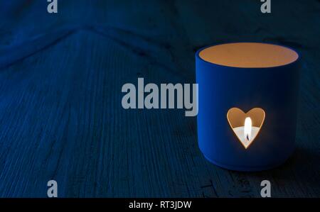 Heart shaped candle holder in blue tones. Stock Photo