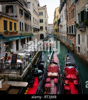 Gondolas moored on a side canal in Venice, Italy. Stock Photo