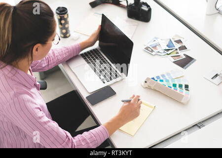 Designer working in office, using laptop Stock Photo