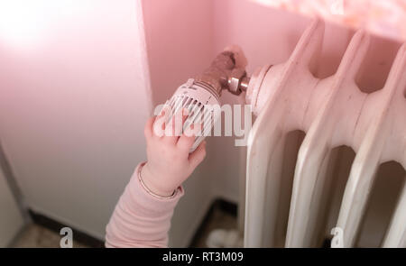 Baby is turning on the heating. Stock Photo