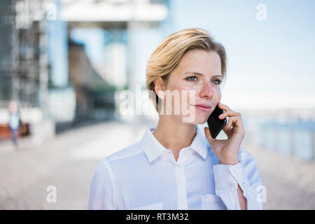 Young businesswoman using mobile phone Stock Photo