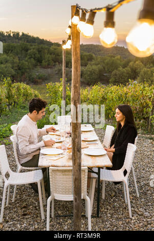 Italy, Tuscany, Siena, young couple having dinner in a vineyard Stock Photo