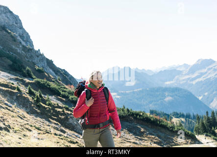 Austria, Tyrol, smiling woman on a hiking trip in the mountains Stock Photo
