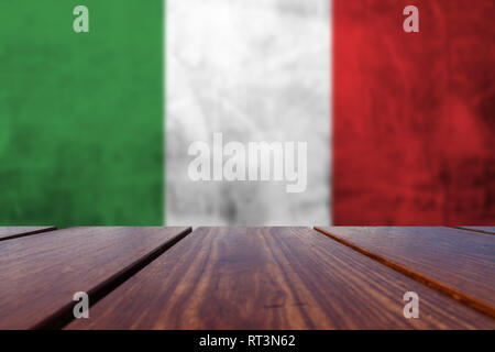Wood Table Top Background and  flag on the grunge concrete wall. Stock Photo