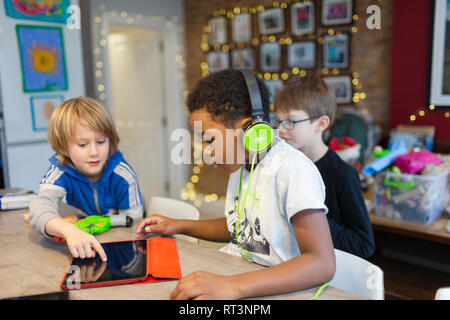 Boys playing video game with digital tablet Stock Photo