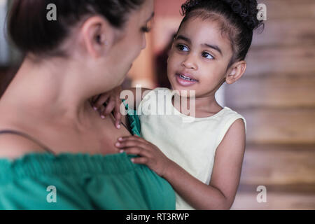 Mother holding toddler daughter Stock Photo