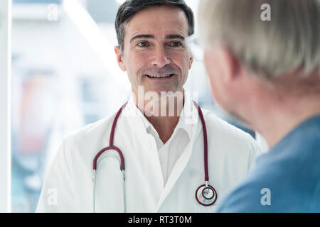 Portrait of smiling doctor looking at patient Stock Photo
