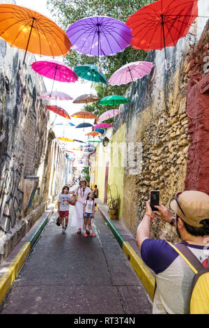 Cartagena Colombia,Center,centre,Getsemani,Callejon Angosto Calle 27 hanging colorful umbrellas,installation,Hispanic ethnic resident residents,narrow Stock Photo