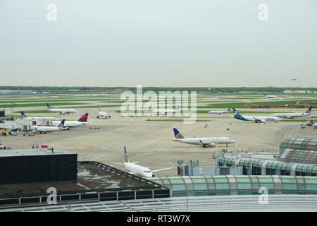 CHICAGO, ILLINOIS, UNITED STATES - MAY 11th, 2018: Several Airlines jet parking on gate position at Chicago O'Hare International Airport in the Stock Photo