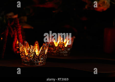 Beautiful burning candles in the candlestick in the form of a crown Stock Photo