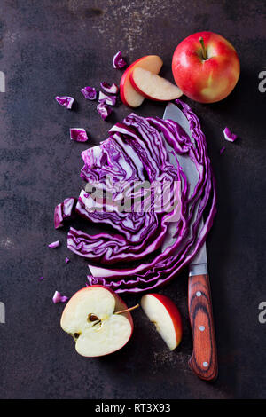 Sliced and red cabbage and apples on rusty ground Stock Photo