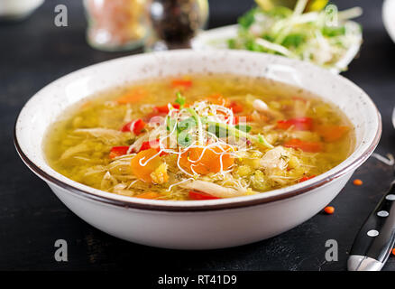 Soup with lentils, carrots, chicken meat, paprika, celery  in a bowl. Stock Photo
