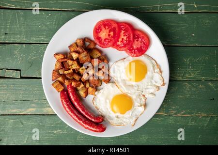 Baked sausage with eggs and potato Stock Photo