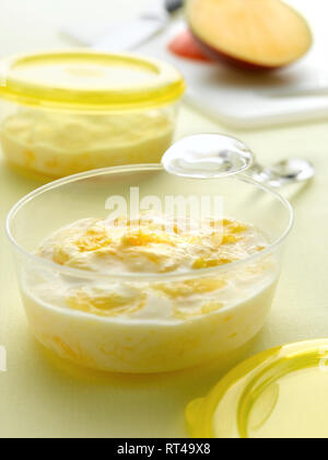 babies mango and yogurt Stock Photo