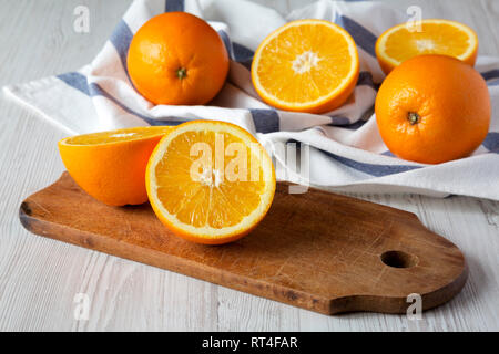 Halved and whole oranges, side view. Close-up. Stock Photo