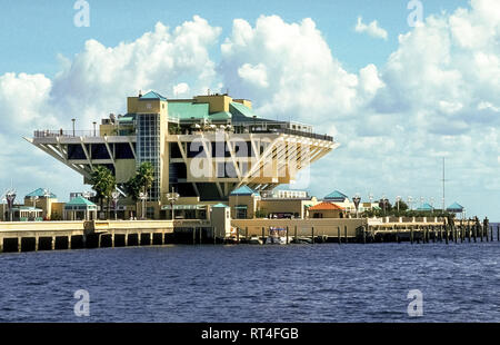 This is an historical photograph of The St. Petersburg Pier, a landmark pleasure pier extending into Tampa Bay from downtown St. Petersburg on the Gulf Coast of Florida, USA. With its novel architectural design of an inverted pyramid, The Pier opened in 1973 but was demolished in 2015 after deteriorating over the years. Construction began soon after on a new $76 million-dollar Pier Park that extends 3,065 feet (934 meters) into the bay and ends with a contemporary four-story Pier Head building featuring a restaurant, gift and bait shop, café and rooftop bar. Stock Photo