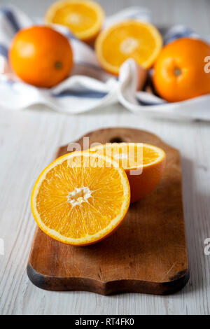 Halved and whole oranges, low angle view. Closeup. Stock Photo