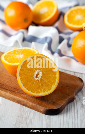 Halved and whole oranges, side view. Closeup. Selective focus. Stock Photo