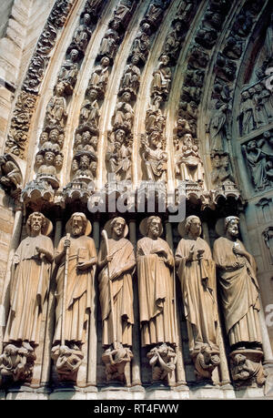 Elaborate stone sculptures decorate the gothic Notre-Dame de Paris, the famous Catholic cathedral in the French capital that features the West Facade with its central doorway that includes these six standing saints carved on the left doorjamb (left to right): Bartholomew, Simeon, James the Less, Andrew, John and Peter. Known as the Portal of the Last Judgment, the ornate doorway was built in the 1220s-1230s as the last of three main entrances to the church. This photograph was taken before the historic church suffered major damage by a disastrous fire in April, 2019, and was closed for repairs