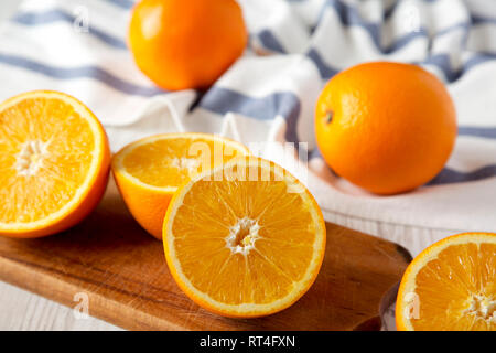 Halved and whole oranges, side view. Close-up. Selective focus. Stock Photo