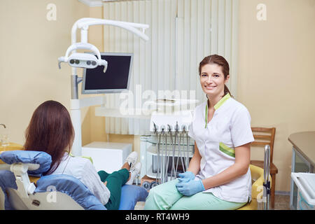 Female dentist smiling in the dental office Stock Photo