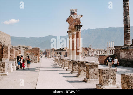 Tourists visiting Roman Forum, Colonnade, Pompeii, travel Italy, pompeii ruins UNESCO site, roman concept, history, archeology, europe, top sites Stock Photo