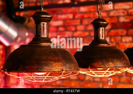 Steampunk style design element lamps hanging view over red brick wall close up Stock Photo