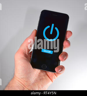 iPhone held in hand - power symbol Stock Photo